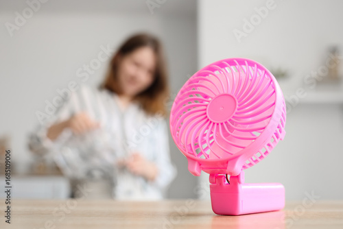 Mini fan on table against w...