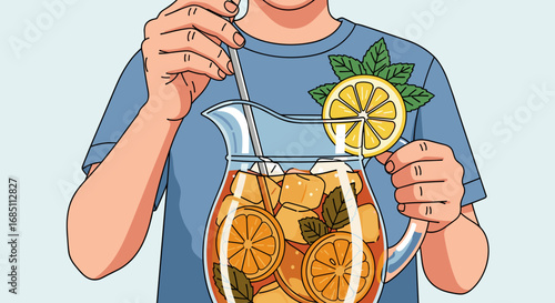 Person stirring iced tea with lemon slices and mint leaves in a glass pitcher wearing a blue shirt