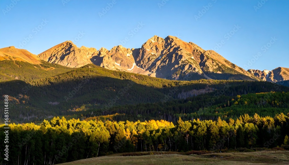 Fototapeta premium Mountain range at dawn with fall foliage