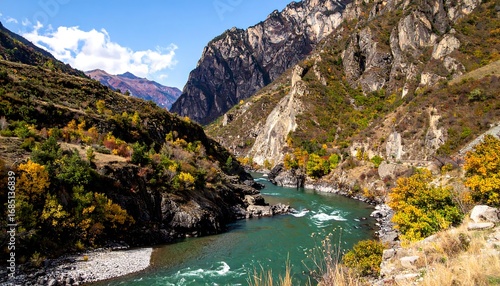 Autumnal river gorge with dramatic mountains