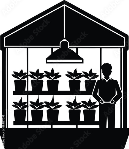 A black and white silhouette shows a person standing inside a greenhouse surrounded by potted plants on shelves under a grow light.