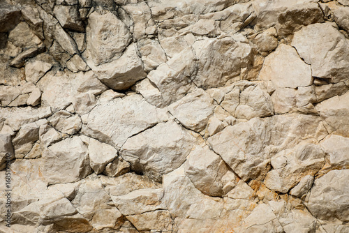 Rough natural stone surface with detailed textures and earthy tones, ideal for geological illustrations, mineral studies, and nature-inspired designs.