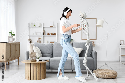 Young woman with human skel...