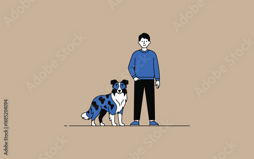 Young man standing next to his loyal blue merle australian shepherd dog