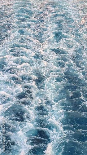 Vertical video: the powerful wake of a cruise ship. A close-up of churning, foamy water creating a hypnotic, abstract pattern. Ideal for social media.