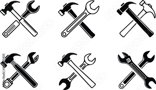 set of crossed hammer and wrench icons, symbolizing repair, construction, and handyman services with vintage style