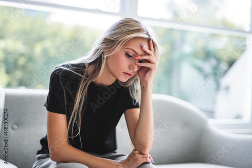 Free Download Portrait beautiful young woman at home on the living room with black shirt look sad - GFXLoad