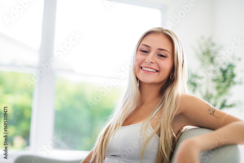 Free Download Portrait beautiful young woman at home on the living room - GFXLoad