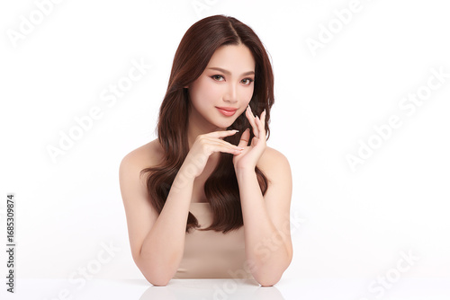A beautiful young Asian woman with clean, fresh skin against a white background. Skincare, facial treatment, cosmetology, beauty, and spa. An elegant portrait of an Asian woman.