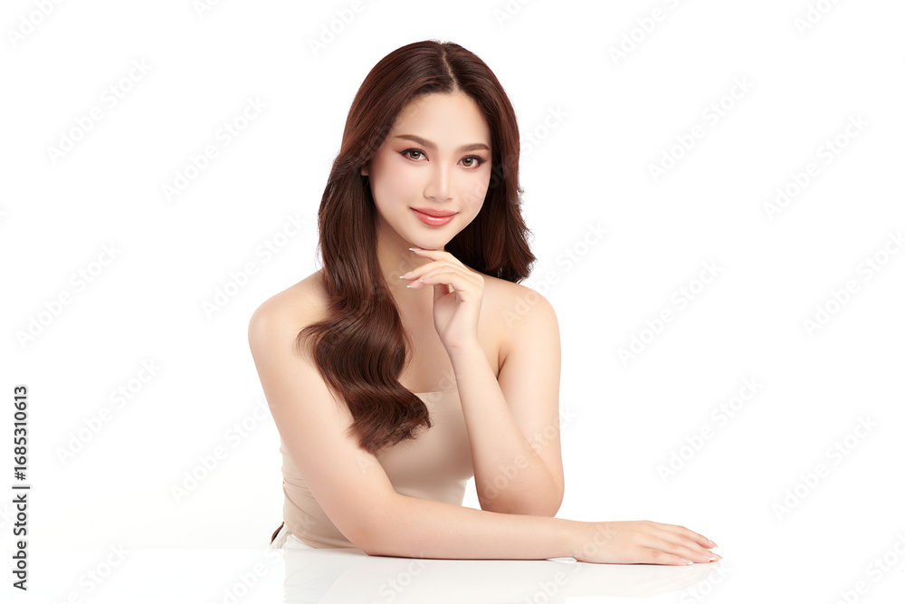 Obraz premium A beautiful young Asian woman with clean, fresh skin against a white background. Skincare, facial treatment, cosmetology, beauty, and spa. An elegant portrait of an Asian woman.