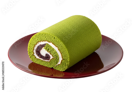 A vibrant green matcha roll cake, adorned with a creamy white filling and red bean paste, rests elegantly on a rich maroon plate against a stark black backdrop.