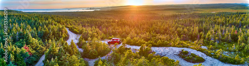 Aerial panorama of overland vehicle camped above the Bay of Fundy, New Brunswick Canada.