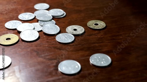 Sendai, Miyagi Prefecture, Japan, September 4, 2025.Money disappearing from a desk. Consumption, waste.A symbol of disappearing money. Time-lapse.