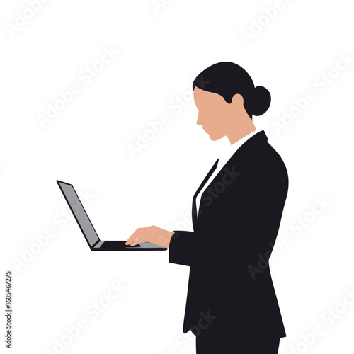 Professional businesswoman in a dark suit working diligently on a laptop computer with a neutral expression