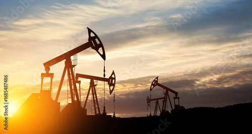 The change in oil prices caused by the war. Oil price cap concept. Oil drilling derricks at desert oilfield. Crude oil production from the ground. Petroleum production.