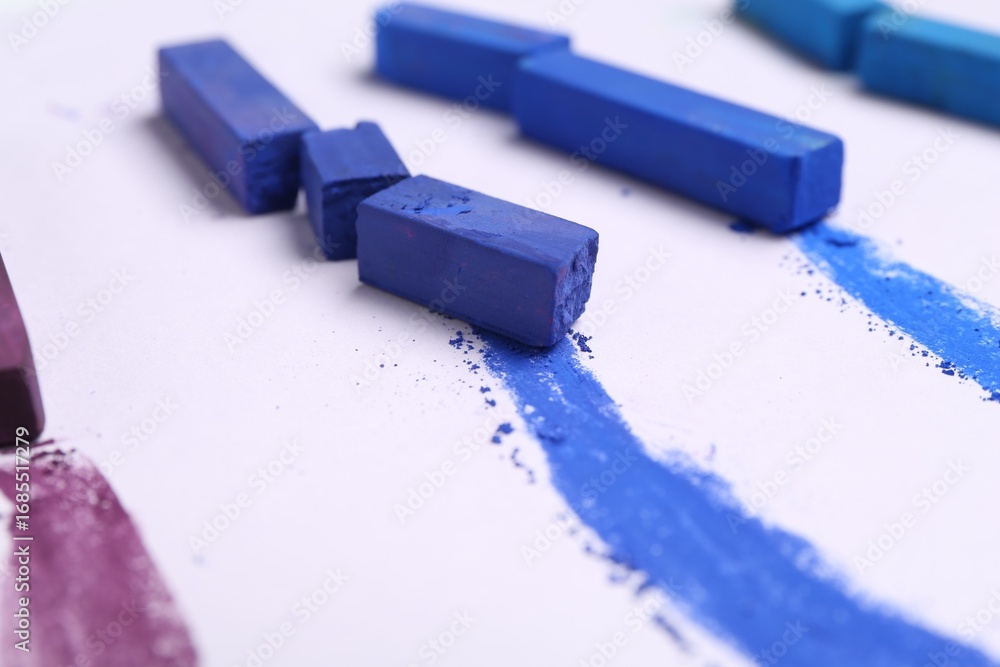 Fototapeta premium Colorful chalk pastels on white background, closeup