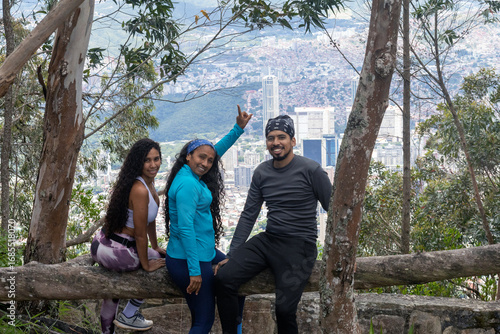 Latino hikers observe Aerial view of Caracas from the mountains of Waraira Repano National Park. Traveling through Venezuela, cityscape of the capital.