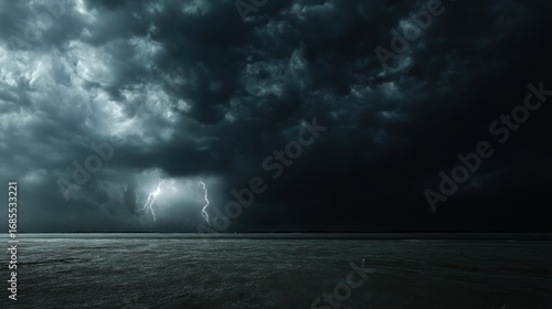 Dramatic stormy sky with two lightning bolts striking over a calm sea, reflecting subtle light on the water surface,
