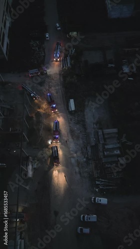 Police and firefighters teamwork at night. Night life in a criminal city. Police cars and fire trucks with in the dark. Joint operation of rescue services 911. Fire extinguishing, emergency situation