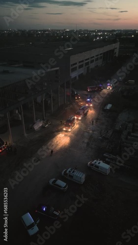 Police and firefighters teamwork at night. Night life in a criminal city. Police cars and fire trucks with in the dark. Joint operation of rescue services 911. Fire extinguishing, emergency situation