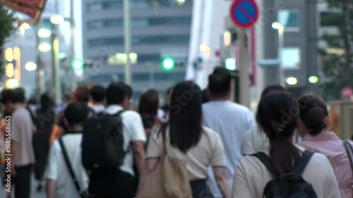 Wallpaper Mural TOKYO, JAPAN - AUG 2025 : Crowd of people (business people) walking at the street near the station in busy night rush hour. Japanese people, business and city life concept 4K video. Torontodigital.ca