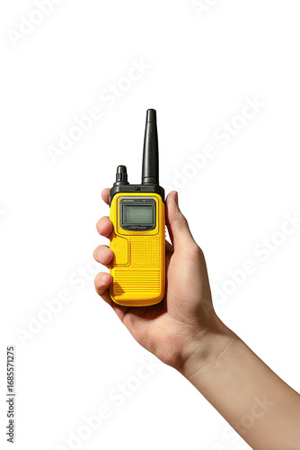 Hand holding a small, yellow two-way radio against a black background