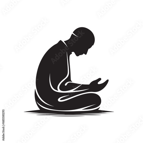Man performing islamic prayer in a dark silhouette