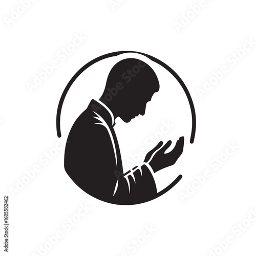 Man performing islamic prayer in a dark silhouette