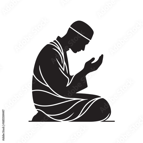 Man performing islamic prayer in a dark silhouette