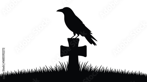 Silhouette of a crow perched on a cross in a graveyard with grass