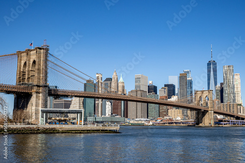 USA, New York, New York City, Brooklyn, DUMBO, View of one of the Stone Towers of the Brooklyn Bridge, Lower Manhattan in the Background