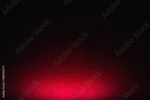 Abstract red glow emanating from the bottom on a deep black background, creating a mysterious gradient with an energetic and dramatic atmospheric effect. This vibrant light offers a powerful, captivat