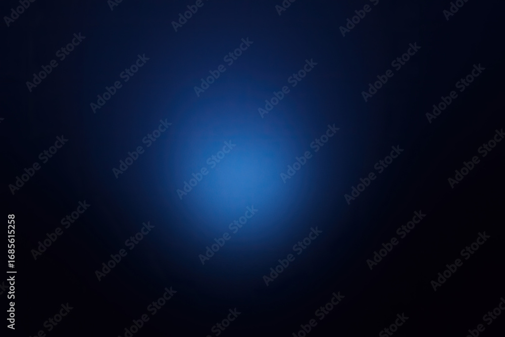 Obraz premium Abstract deep navy blue background with a radiant central bright light creating a soft, ethereal vignette effect. Perfect for modern designs, digital projects, tech presentations, futuristic concepts,
