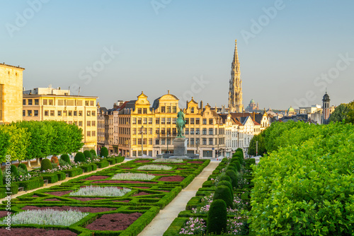 Empty Mont des Arts Square Early Morning. Green Garden, Clear Sky and Spire of Town Hall. City of Brussels, Belgium. Golden Hour