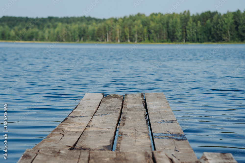 Fototapeta premium tranquil landscape, relaxing scene, wooden pier and country lake, blue water and green forest in smooth horizone line