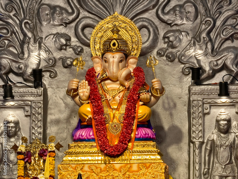 Fototapeta premium 27 August 2025, Pune, Maharashtra, India, Beautiful sculpture of Lord Ganesh called as Tambdi Jogeshwari Ganpati near ABC chowk, Pune, during Ganesh Utsav Festival 2025.