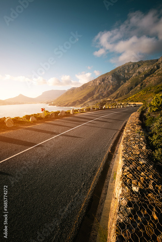 Scenic road along Ocean and Mountains at sunset. Chapman’s Peak Drive.