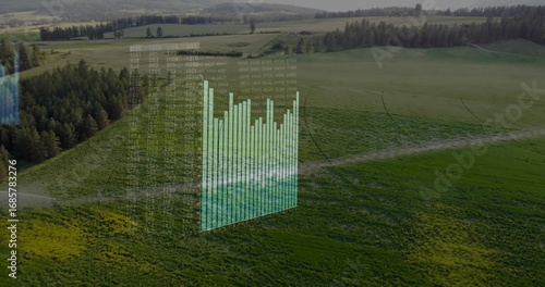 Displaying holographic overlay with 3D bar chart and floating numeric matrix above rural farmland