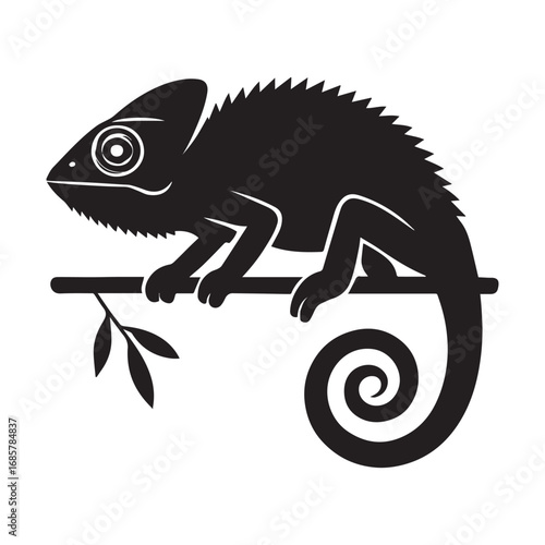 Black chameleon perched on branch with leaves reptile