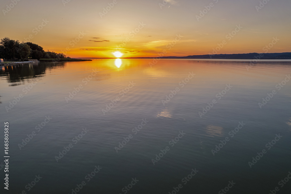Fototapeta premium Spectacular sunset over lake Balaton with golden reflections, Hungary.
