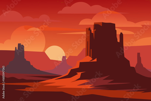 A beautiful sandstone monument silhouette against a fiery desert sky at sunset in Monument Valley, Arizona