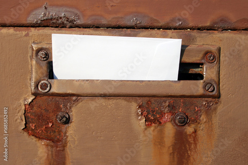 An envelope placed in retro styled mailbox with patina