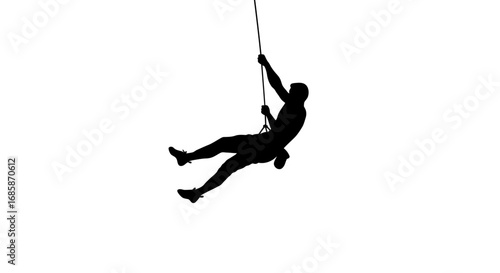 Silhouette of a climber dangling from a rope