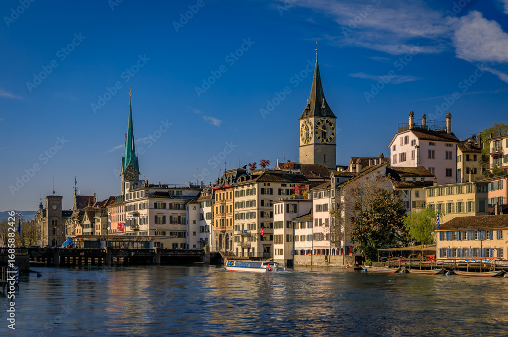 Fototapeta premium Cityscape with historic buildings and churches on the Limmat, Zurich Switzerland