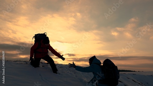 Teamwork of business people. Go to your goal. Travelers climb snowy mountain together. Silhouettes of climbers reaching out to each other, climbing to top of the hill. Victory of business team. Travel