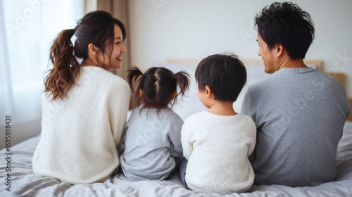 Japanese family enjoying intimate moment together on bed