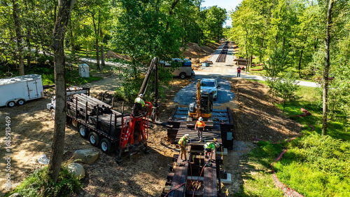 Φωτογραφία Workers are engaged in constructing an outdoor trail in a wooded area