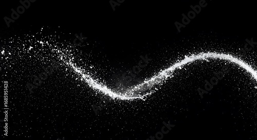Dynamic splash of white particles forming a sinuous trail against a stark black backdrop, creating movement.
