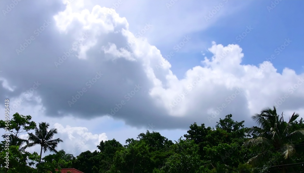 Fluffy clouds over lush greenery Fluffy clouds over lush greenery