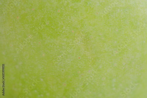 Green apple as a background macro photo.